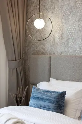 a bedroom with a bed with a light above it at City Views, Pool & Gym Near Iconic Burj Khalifa in Dubai