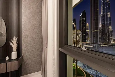 a room with a window with a view of a city at City Views, Pool & Gym Near Iconic Burj Khalifa in Dubai