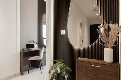 a room with a desk and a mirror on a wall at City Views, Pool & Gym Near Iconic Burj Khalifa in Dubai