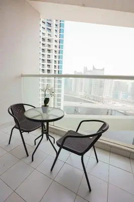a table and two chairs in a room with a window at Luxurious Studio in Heart of Business Bay in Dubai
