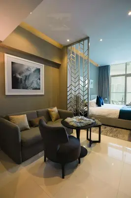 a living room with a couch and a bed at Luxurious Studio in Heart of Business Bay in Dubai