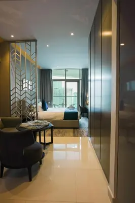 a hotel room with a bed and a table at Luxurious Studio in Heart of Business Bay in Dubai