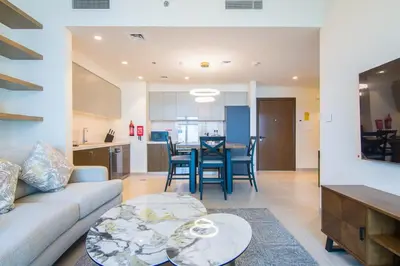 a living room with a couch and a table at Forte, Downtown- Elegant 1-BR in Dubai