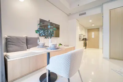 a kitchen with a table and a chair at Cozy High-Floor Studio with Amazing Views in Dubai