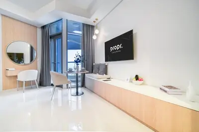 a room with a reception desk and a mirror at Cozy High-Floor Studio with Amazing Views in Dubai