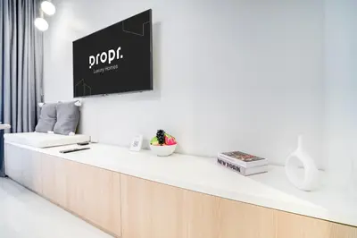 a reception desk with a tv on a wall at Cozy High-Floor Studio with Amazing Views in Dubai