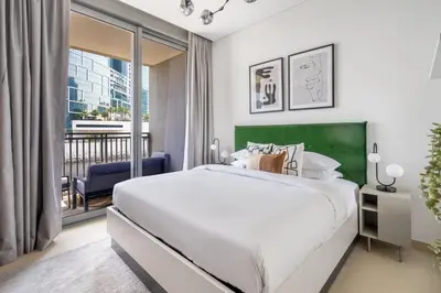 a bedroom with a large bed and a balcony at GuestReady - Marvellous stay in Marina | Canal View in Dubai