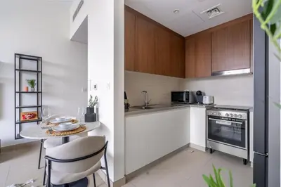 a small kitchen with a table and a stove at GuestReady - Marvellous stay in Marina | Canal View in Dubai