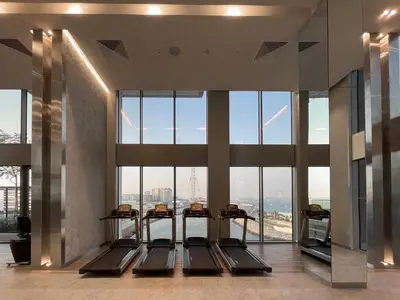 a gym with a view of the eiffel tower at GuestReady - Marvellous stay in Marina | Canal View in Dubai