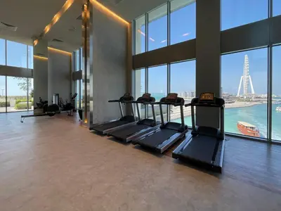 a gym with a bunch of treadmills in a building at GuestReady - Marvellous stay in Marina | Canal View in Dubai