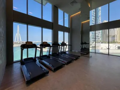 a gym with a view of the eiffel tower at GuestReady - Marvellous stay in Marina | Canal View in Dubai
