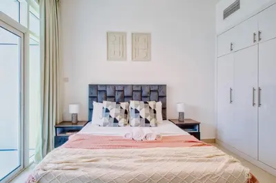 a bedroom with a bed with two towels on it at ShoresInn - Charming 1BR with Marina Views in Dubai