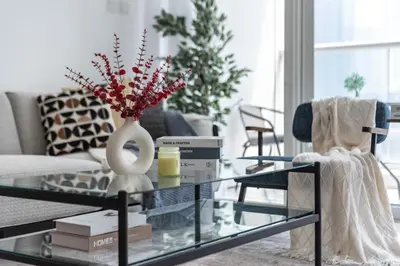 a living room with a glass coffee table at ShoresInn - Charming 1BR with Marina Views in Dubai