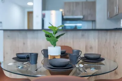 a glass table with a potted plant on top of it at ShoresInn - Charming 1BR with Marina Views in Dubai