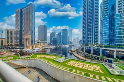 a river in a city with tall buildings at ShoresInn - Charming 1BR with Marina Views in Dubai