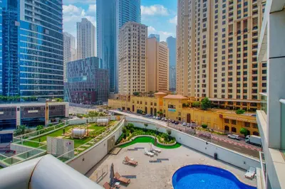a view of a city with tall buildings and a pool at ShoresInn - Charming 1BR with Marina Views in Dubai