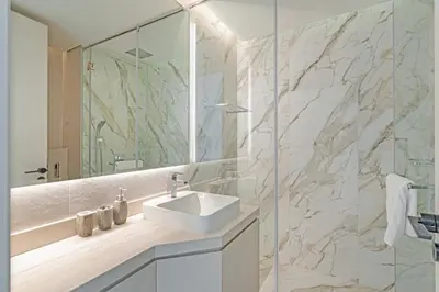 a bathroom with a sink and a mirror at Savis Homes - Condor Marina Star - Luxury 2 BR Waterfront Apartment in Dubai