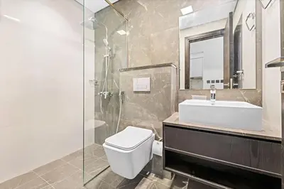 a bathroom with a toilet and a sink and a shower at Amazing 1 Bdr luxury residence Dubai Arjan in Dubai