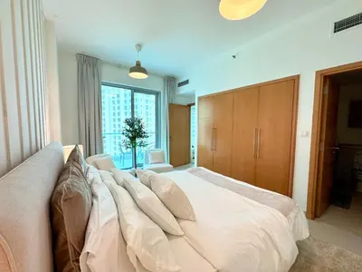 a large bed in a room with a large window at Amazing 1BR in Dubai Marina with Luxury Interiors in Dubai