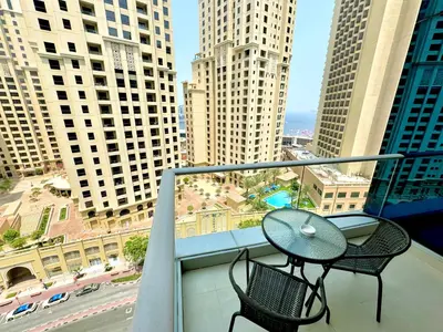 a balcony with two chairs and a table on a balcony at Amazing 1BR in Dubai Marina with Luxury Interiors in Dubai