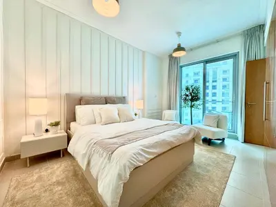a bedroom with a large bed and a large window at Amazing 1BR in Dubai Marina with Luxury Interiors in Dubai