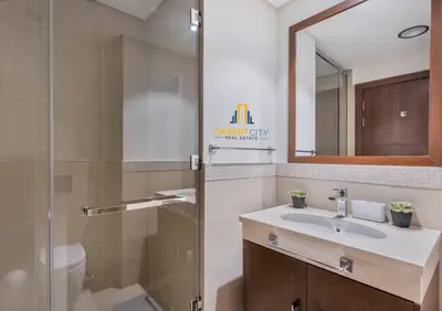 a bathroom with a sink and a shower and a mirror at Luxurious 2 Bed Next to Burj Khalifa, Hosted by Desert City Stays in Dubai