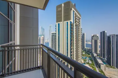 a balcony with a view of a city at Creekside, Creek Harbour 1 BDR in Dubai