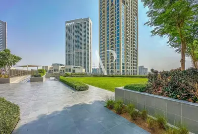 a walkway in the middle of a city with tall buildings at Creekside, Creek Harbour 1 BDR in Dubai