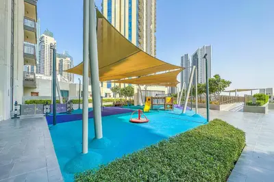 a playground with a tent and a slide at Creekside, Creek Harbour 1 BDR in Dubai