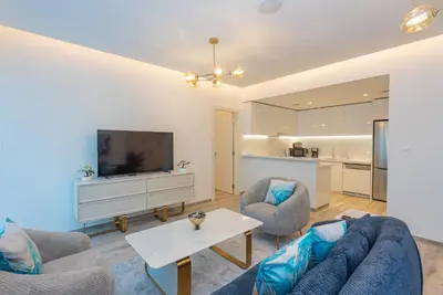 a living room with a couch and a tv at Spacious 1br in Ahad, Business Bay in Dubai