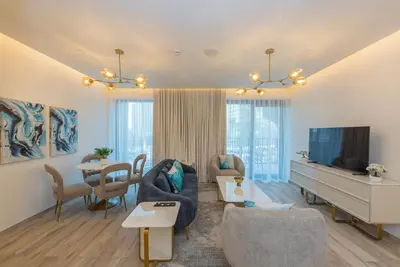 a living room with a couch and a tv at Spacious 1br in Ahad, Business Bay in Dubai
