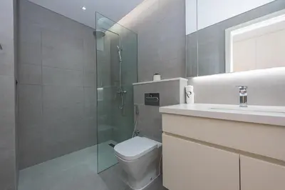 a bathroom with a shower and a toilet and a sink at Spacious 1br in Ahad, Business Bay in Dubai