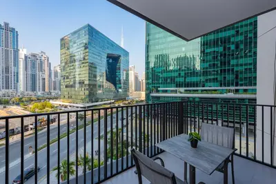 a balcony with a table and chairs and a city at Spacious 1br in Ahad, Business Bay in Dubai