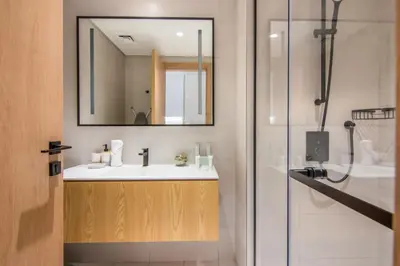 a bathroom with a sink and a mirror at Marquise Square Studio, Business Bay in Dubai