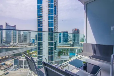 a balcony with chairs and a view of a city at Marquise Square Studio, Business Bay in Dubai