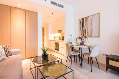 a living room with a couch and a table at Marquise Square Studio, Business Bay in Dubai