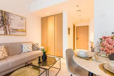 a living room with a couch and a table at Marquise Square Studio, Business Bay in Dubai
