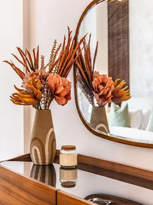 a bathroom counter with two vases and a mirror at Prestigious 2BR-Noura Tower- Business Bay in Dubai