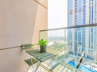 a balcony with a table and a potted plant at Prestigious 2BR-Noura Tower- Business Bay in Dubai