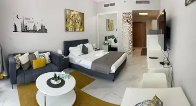 a living room with a bed and a couch at Millennium Binghatti Residence in Dubai