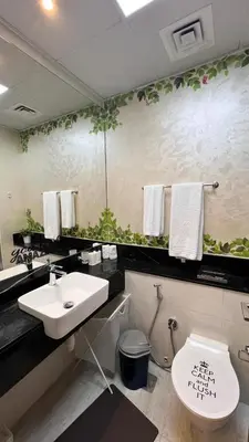 a bathroom with a sink and a toilet at Millennium Binghatti Residence in Dubai