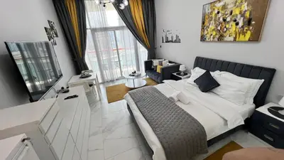 a bedroom with a bed and a living room at Millennium Binghatti Residence in Dubai