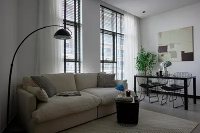 a living room with a white couch and a table at Luxury 1Br apartment, Canal view in Dubai