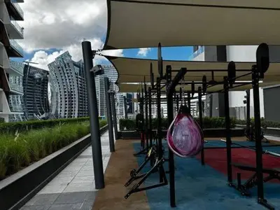 a swingiety on top of a building in a city at Luxury 1Br apartment, Canal view in Dubai