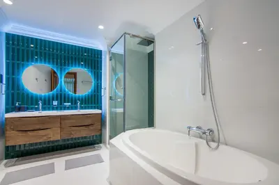 a bathroom with a tub and a sink and a shower at Fairmont Residences, Exquisite 2BR Luxury Retreat in Dubai