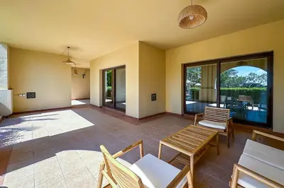 a living room with chairs and a table and windows at Fairmont Residences, Exquisite 2BR Luxury Retreat in Dubai