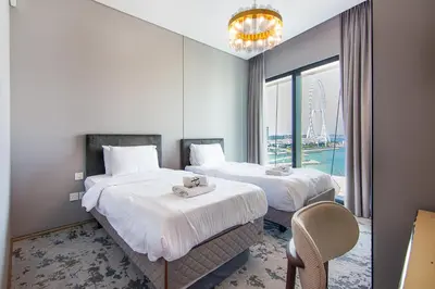 a hotel room with two beds and a window at Address Residential 2 BDR, JBR in Dubai