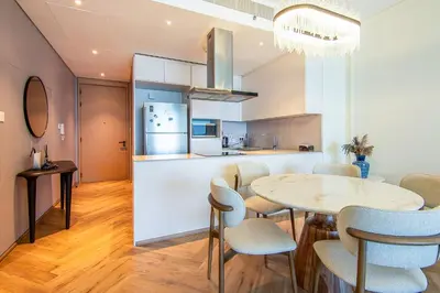 a kitchen and dining room with a table and chairs at Address Residential 2 BDR, JBR in Dubai