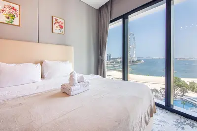 a bedroom with a large bed and a large window at Address Residential 2 BDR, JBR in Dubai