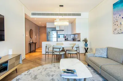a living room with a couch and a table at Address Residential 2 BDR, JBR in Dubai